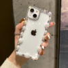 Transparent iPhone cover with a pearl design around the edges, offering a chic, elegant look while providing durable protection.