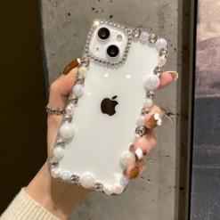 Transparent iPhone cover with a pearl design around the edges, offering a chic, elegant look while providing durable protection.