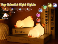 Soft silicone duck night light in a reclining "lazy" pose, emitting a warm, gentle glow in a dark room.