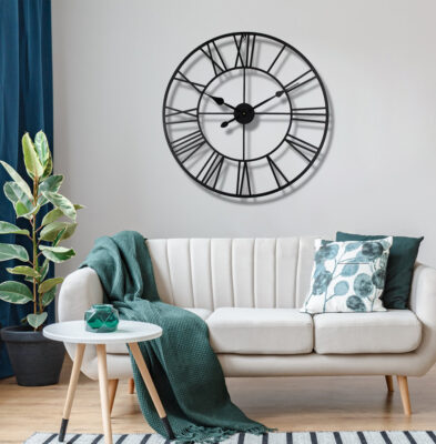 Decorative 80cm metal skeleton wall clock in a distressed black finish, showing the wall through its design.